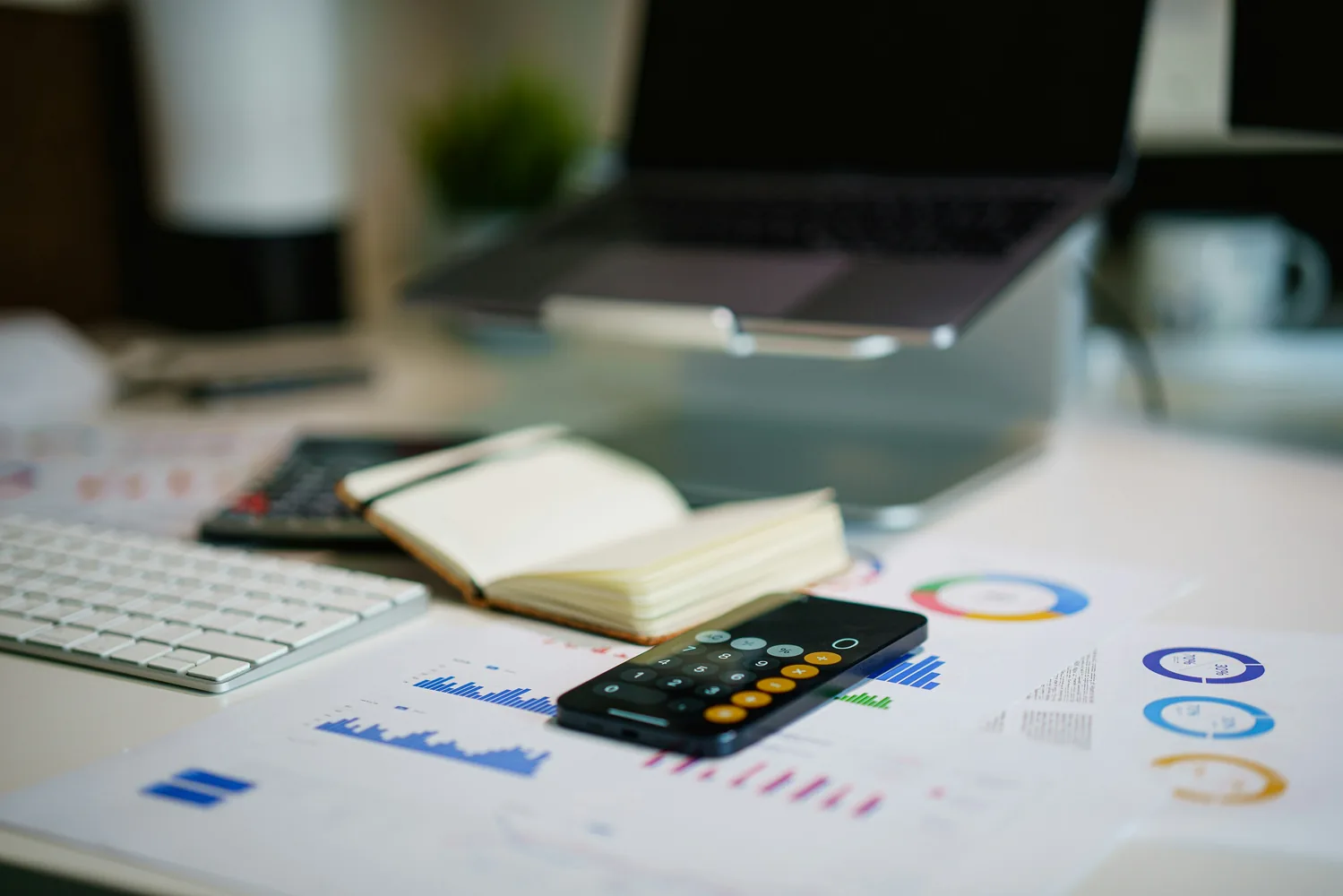 Calculator and financial documents used to plan a home purchase